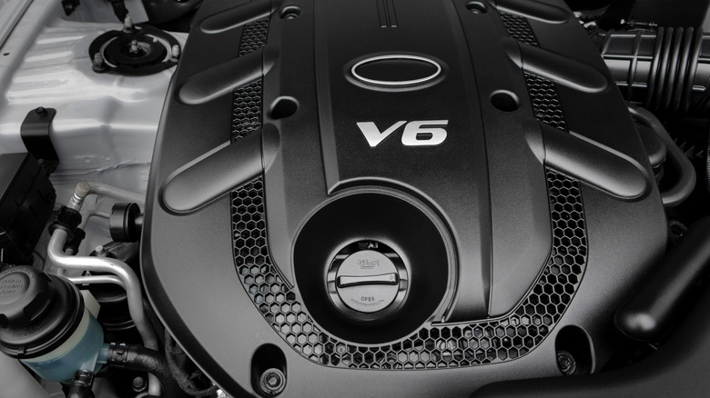 Closeup of the exterior of a sleek black V6 engine
