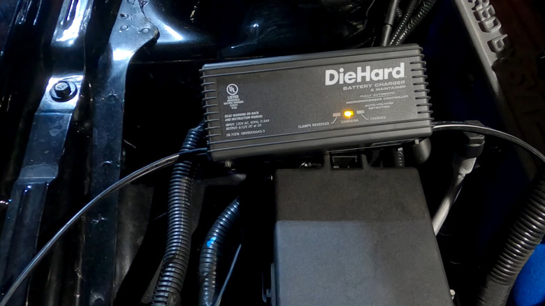 A trickle charger connected to a car battery