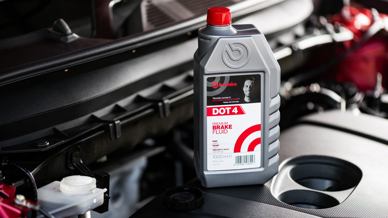Brake fluid container sitting on engine with brake fluid reservoir open