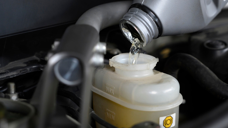 Brake fluid being poured into brake fluid reservoir