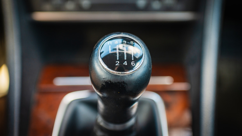A closeup of a stick shift in a manual vehicle