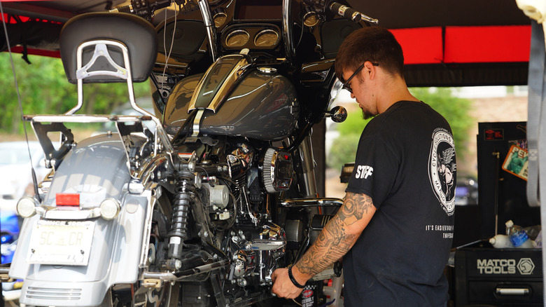 Man working on Harley-Davidson motorcycle