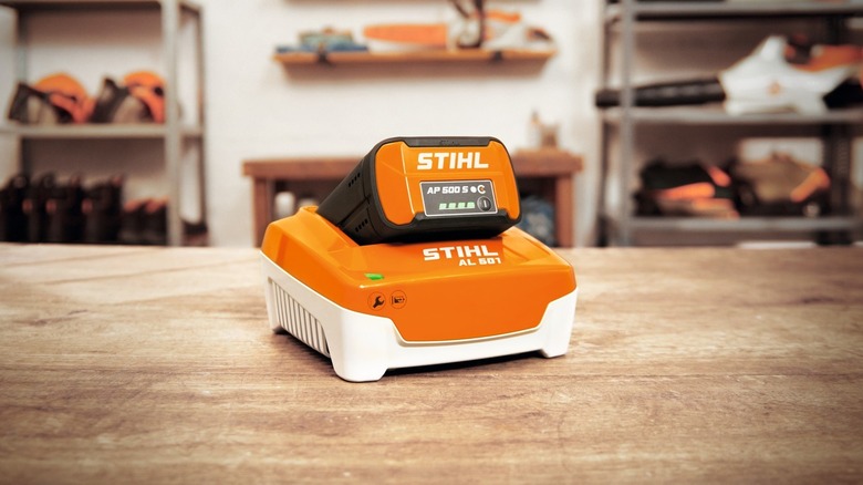Stihl AL 501 charger on workshop table with AP battery connected