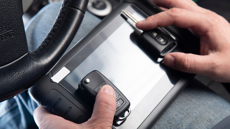 A person reprogramming car keys