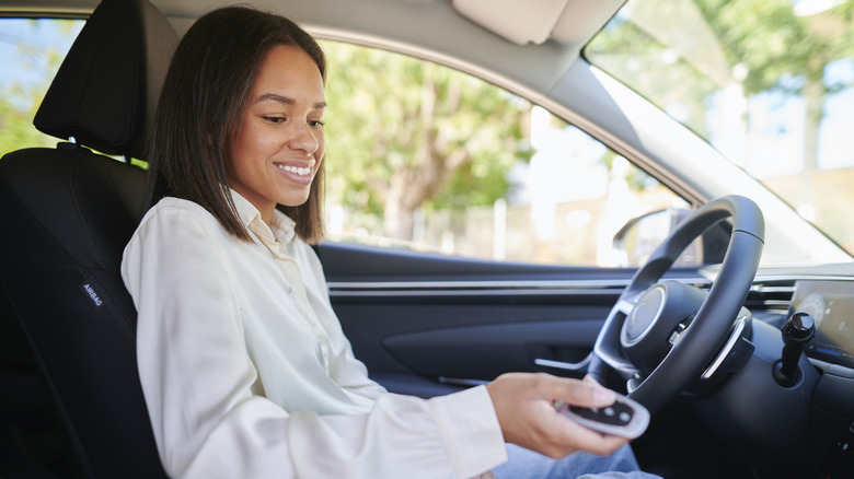 A woman with an electronic car key fob