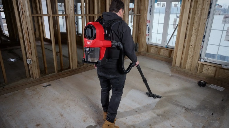A person using Milwaukee's M18 Fuel 3-in-1 Backpack Vacuum