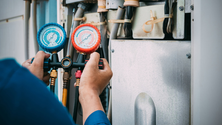 An air conditioner technician checking refrigerant levels.