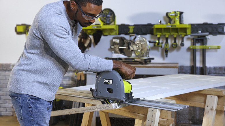 Man using Ryobi track saw