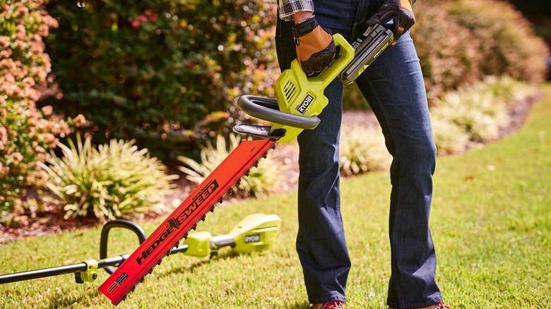 person holding a Ryobi 40V 24-inch Hedge Trimmer