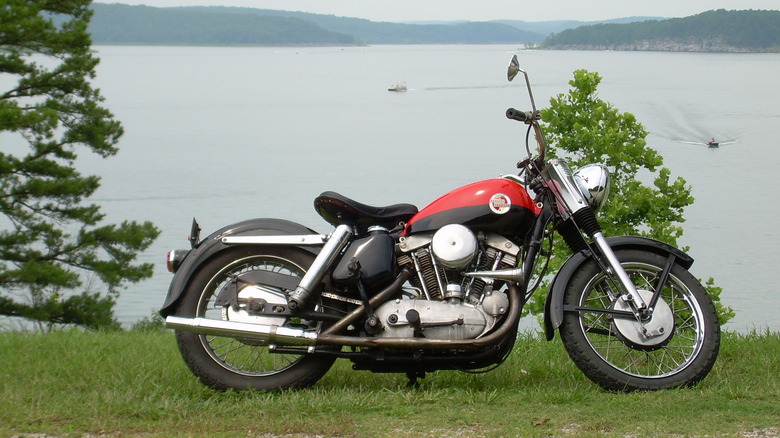A 1957 Harley-Davidson XL Sportster parked with Norfork Lake in the background.