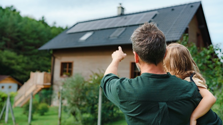 Father child pointing to solar panels