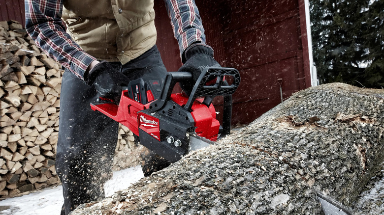 Mid-cut action shot of the Milwaukee M18 Fuel 16 inch chainsaw