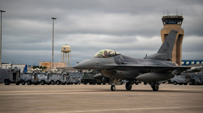 F-16 fighter taxiing under cloudy skies at Tyndall Air Force in Florida.