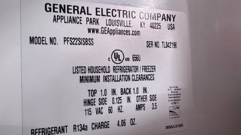 A close up of the model sticker inside the door of a GE side-by-side fridge