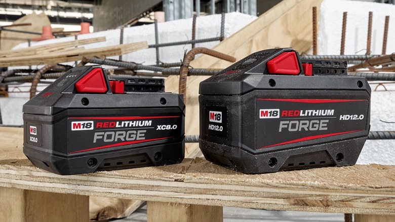 Two M18 batteries on wooden stand