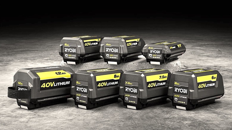 Multiple Ryobi 40V Lithium batteries displayed on a concrete surface