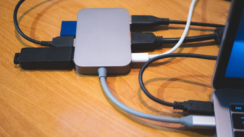 USB-C hub plugged into laptop with multiple devices attached