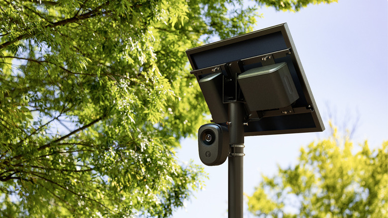 A Flock Safety camera and solar panel on a pole