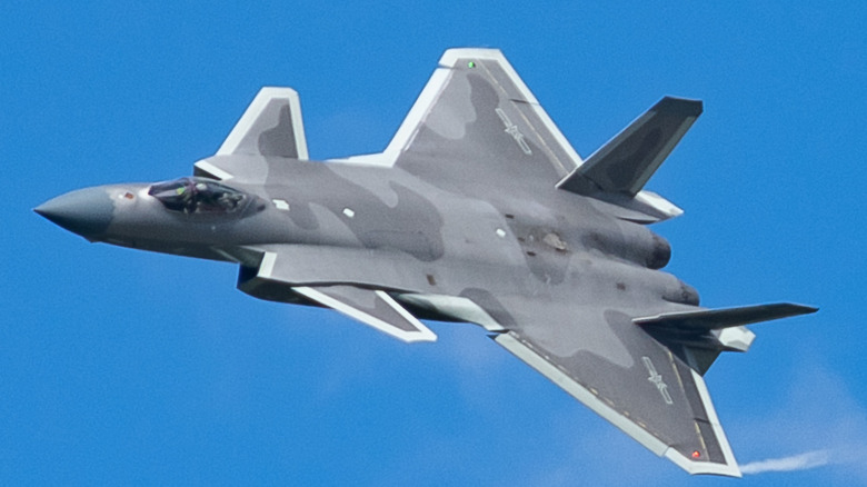J-20 flying against a cloudless blue sky