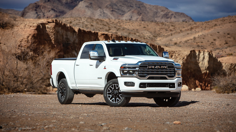 A white 2025 RAM 2500 HD, Longhorn trim level, front 3/4 view, desert setting