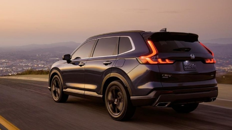 The 2025 Honda CR-V pictured from the rear traveling on an asphalt road