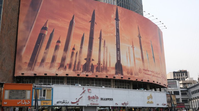 A banner depicting various IRGC missiles hangs from a Tehran building in April 2024