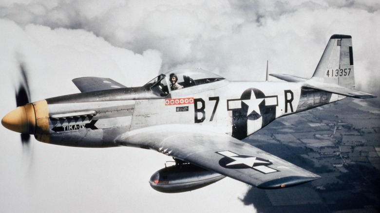 P-51D-5NA Mustang flying over cloudy skies as the pilot looks at the camera in 1944