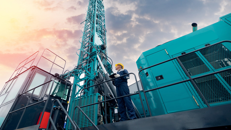 Oil rig staff member holding tablet