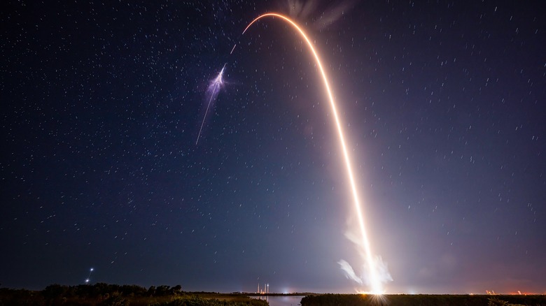 A Space X rocket launched into orbit with the night sky in the backdrop.