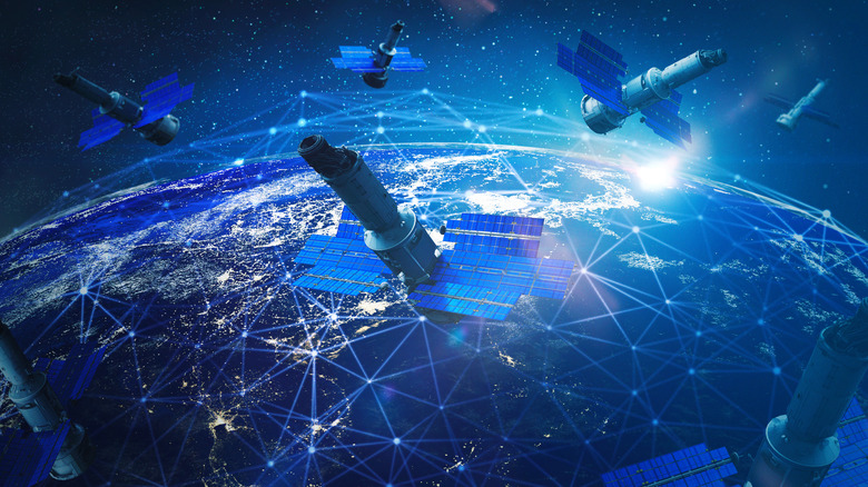 Depiction of earth from space with sky crowded with satellites