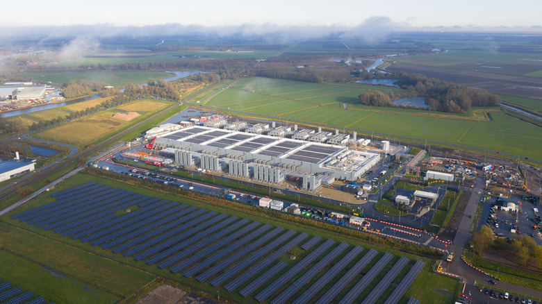 A data center with a large solar farm beside it.