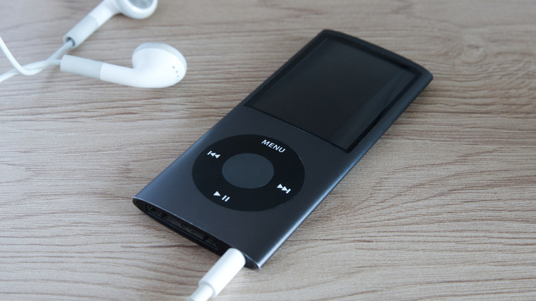 A black iPod Nano with wired earbuds.