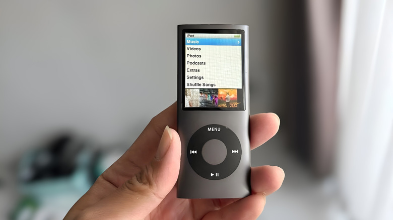 An iPod Nano showing albums on the screen.