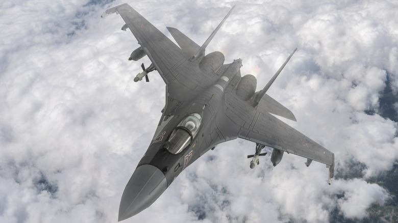 A Russian SU-35 flying over clouds