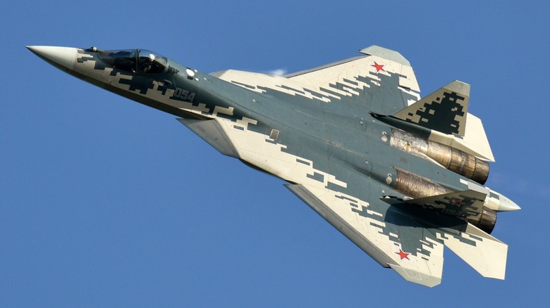 An Sukhoi Su-57 climbing over blue skies