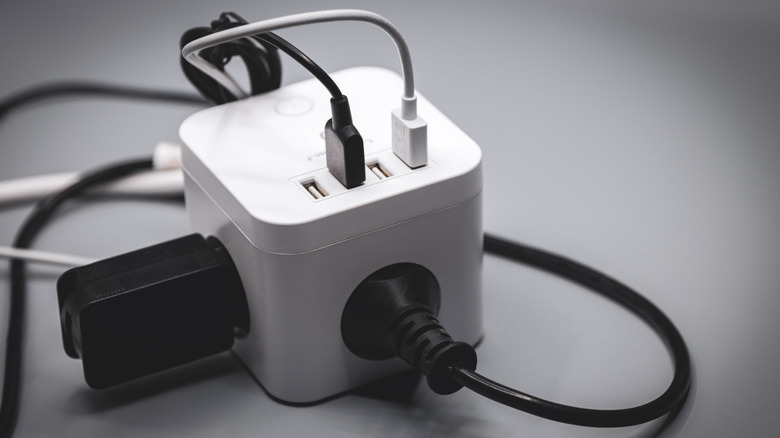 white cube multiport charger with four USB-A ports and other ports as well