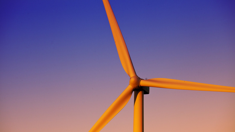 A wind turbine shown at dusk