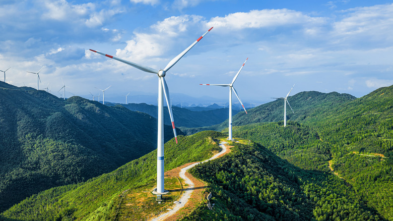 Wind turbines on a lush mountain ridge