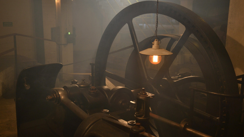 An image of an old steam engine in a warehouse