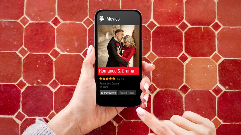 Choosing a movie to watch on a smartphone.