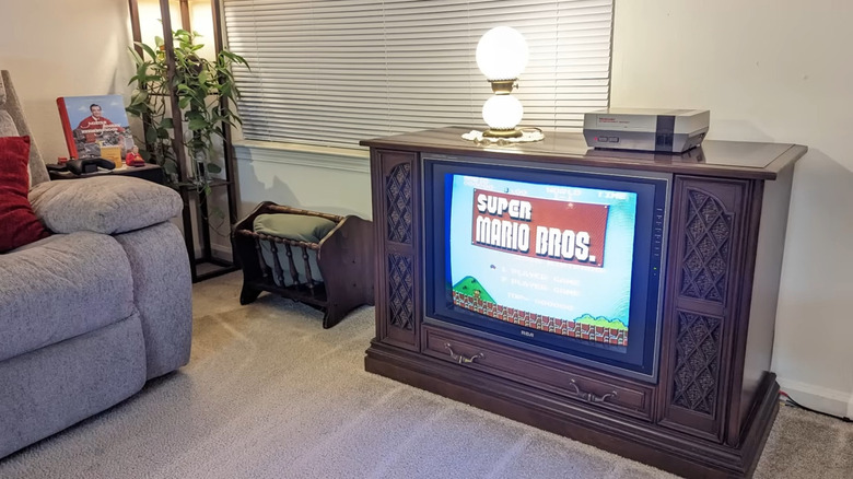 An old RCA console television sitting in a living room.