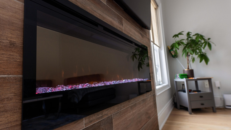 A stylish built-in electric fireplace surrounded by wooden panels