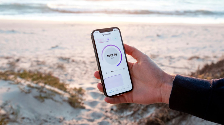 phone on beach displaying data speed