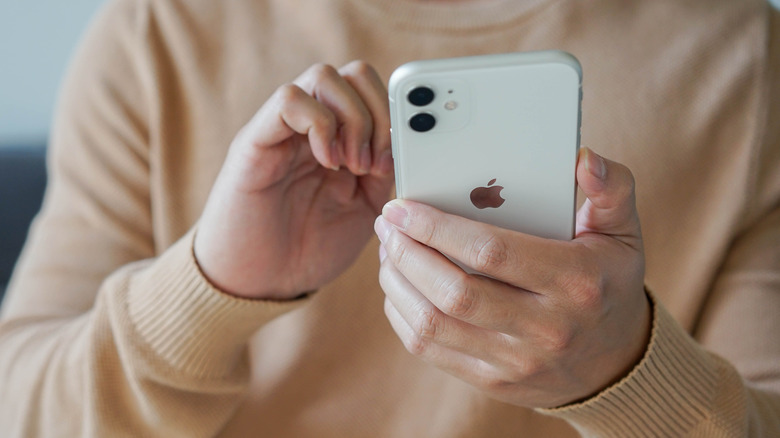 iPhone 11 held by a user