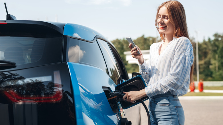 Woman charging an EV