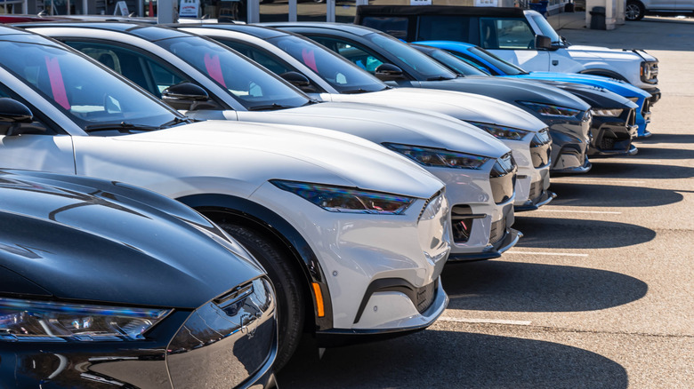 A row of new blue, black, grey, and red Jeep utility vehicles