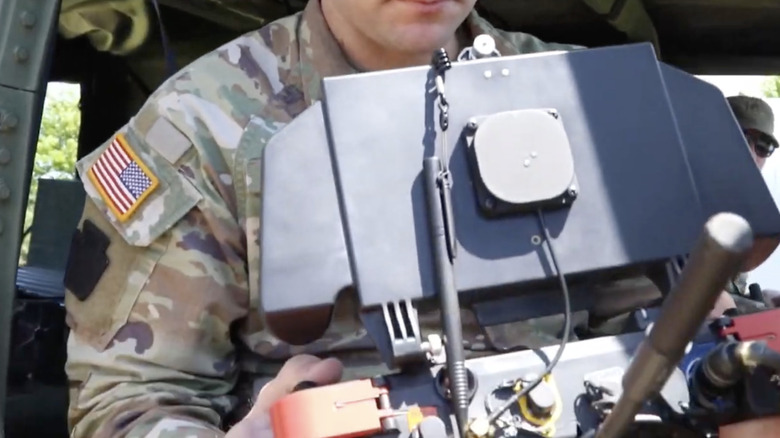 A US Military drone pilot holds a remote control