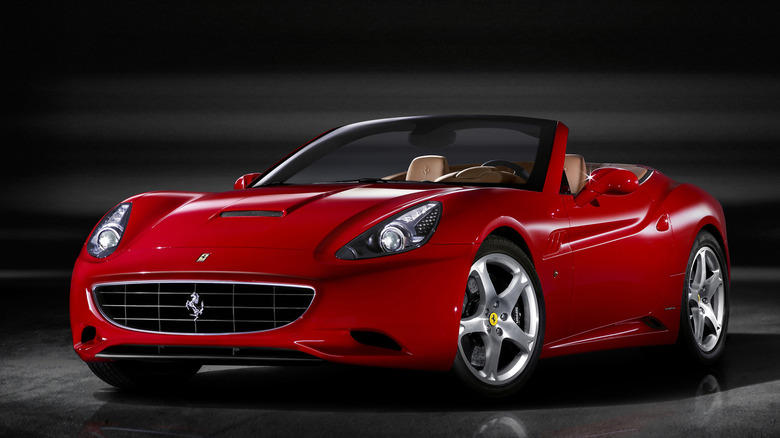 Red Ferrari California with top down in studio setting