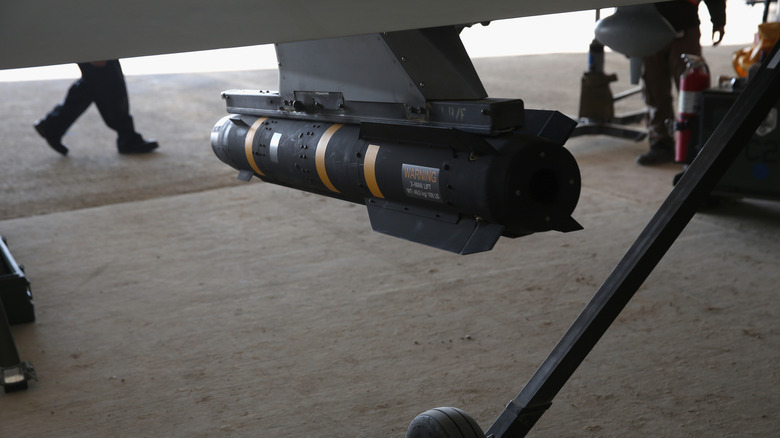 Hellfire missiles beneath a military vehicle.