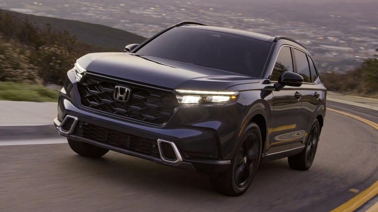 Front 3/4 view of Honda CR-V on curving mountain road
